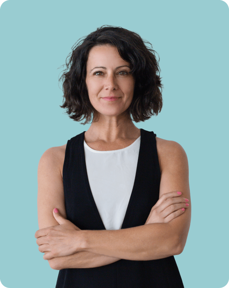 A content woman standing confidently with arms crossed