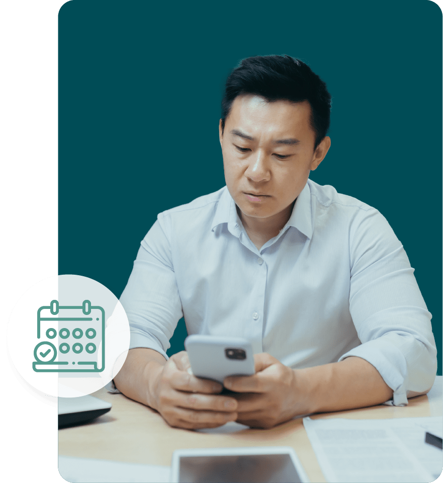 A man reading his phone to see when his lat filing was and a calendar