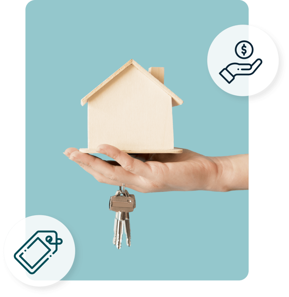 Hand holding wooden model of house with a key on a key ring